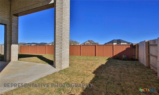 view of yard with a patio and a fenced backyard