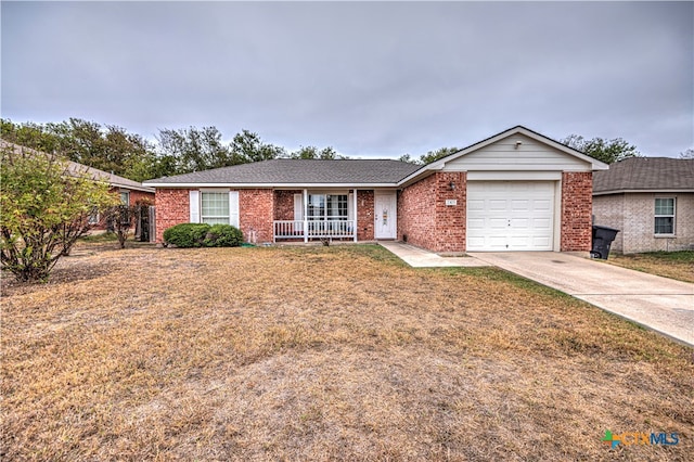 single story home with covered porch and a garage