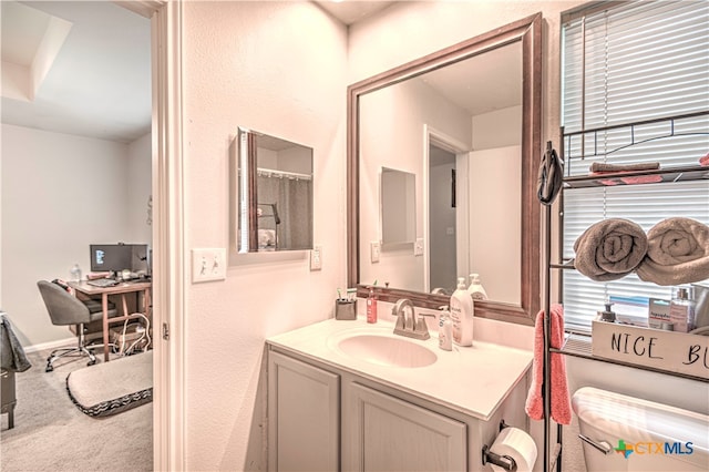 bathroom with vanity and toilet