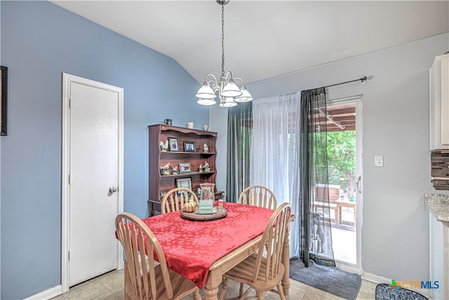 dining area featuring lofted ceiling and a notable chandelier