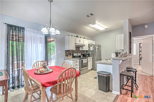 kitchen with white cabinetry, stainless steel appliances, light stone counters, a chandelier, and decorative light fixtures