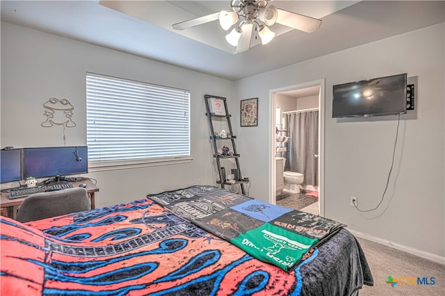 bedroom with ensuite bathroom, ceiling fan, and carpet floors