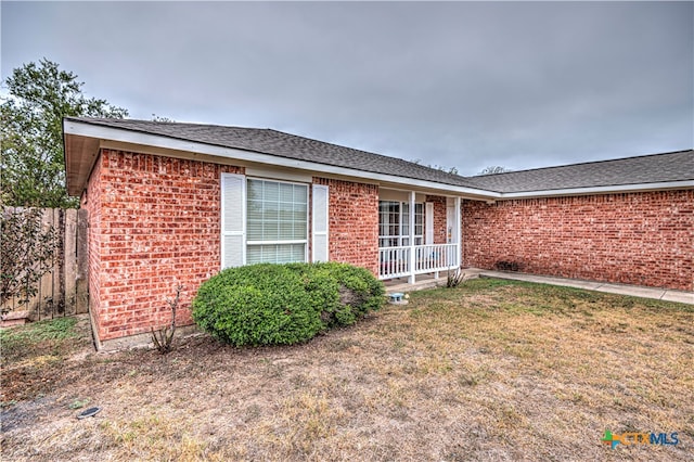 rear view of house featuring a lawn