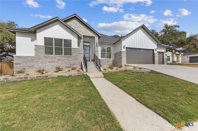 view of front of home featuring a garage, concrete driveway, stone siding, board and batten siding, and a front yard