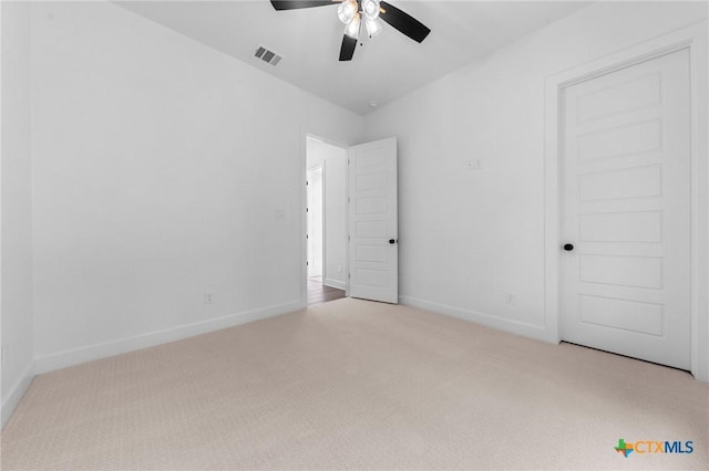 unfurnished bedroom featuring a ceiling fan, carpet, visible vents, and baseboards