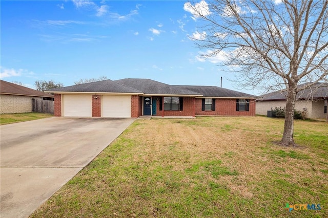 single story home with concrete driveway, brick siding, a front lawn, and a garage