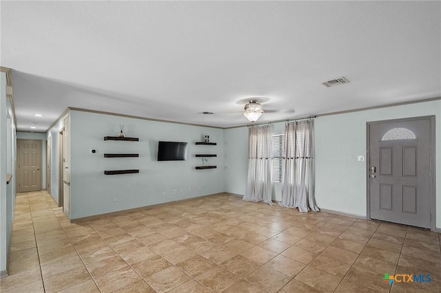 interior space featuring visible vents, a ceiling fan, and baseboards