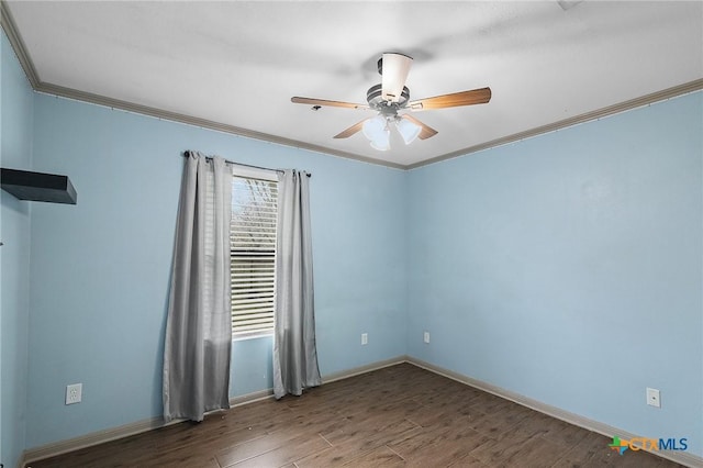 spare room featuring baseboards, ornamental molding, ceiling fan, and wood finished floors
