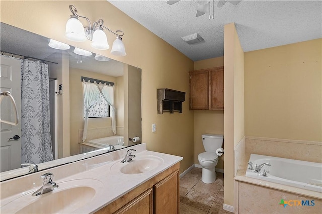 bathroom featuring a sink, tile patterned flooring, a garden tub, and toilet