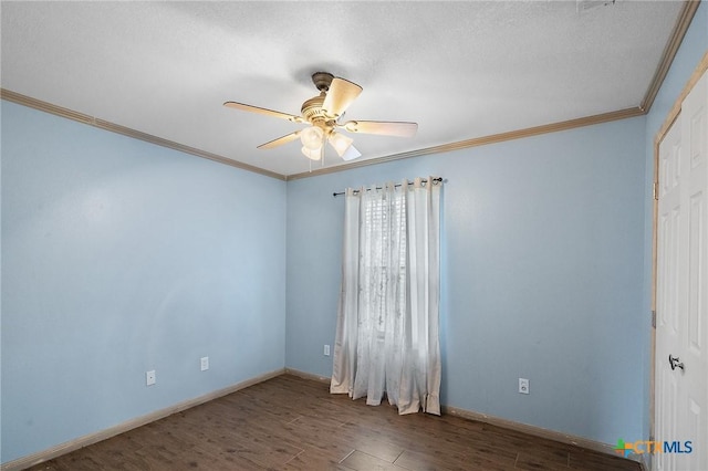 empty room featuring baseboards, ornamental molding, a ceiling fan, and wood finished floors