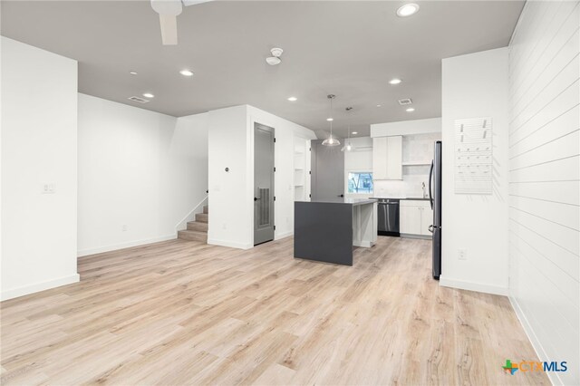 1208 N Academy Ave Unit 3203, New Braunfels, TX 78130 - kitchen featuring dishwashing machine, freestanding refrigerator, a kitchen island, recessed lighting, and white cabinets