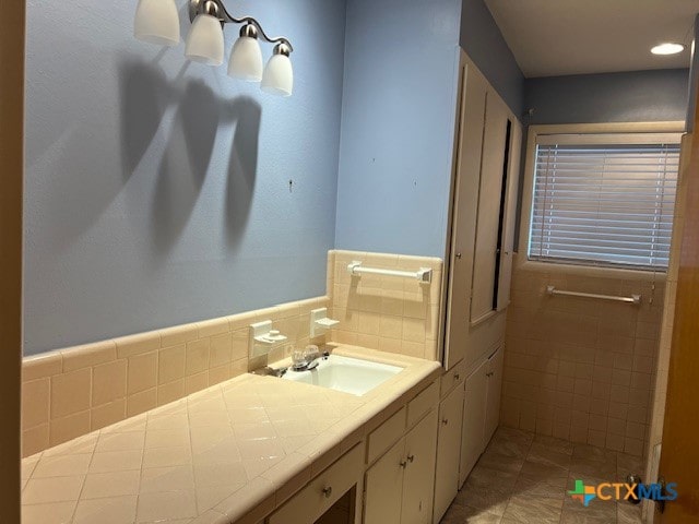 bathroom featuring sink, tile walls, and tile patterned flooring