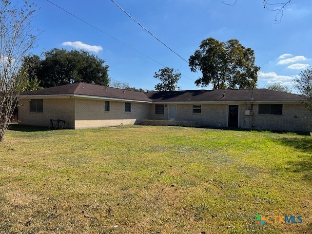 rear view of house with a yard