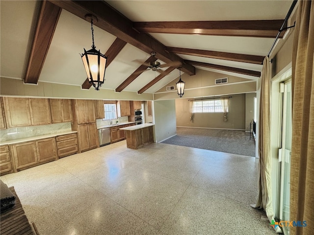 kitchen with open floor plan, light countertops, brown cabinetry, appliances with stainless steel finishes, and vaulted ceiling with beams