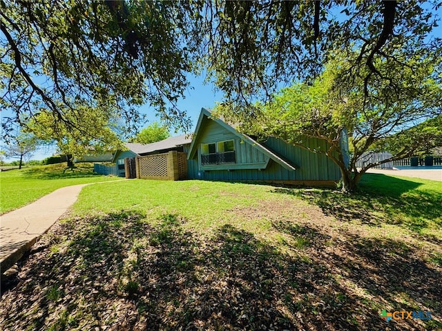 view of side of home featuring a lawn