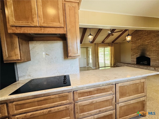 kitchen with a brick fireplace, black electric cooktop, lofted ceiling with beams, open floor plan, and ceiling fan