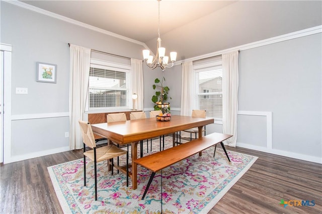 dining area with ornamental molding, wood finished floors, and a notable chandelier