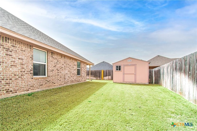 view of yard with a fenced backyard, an outdoor structure, and a storage shed