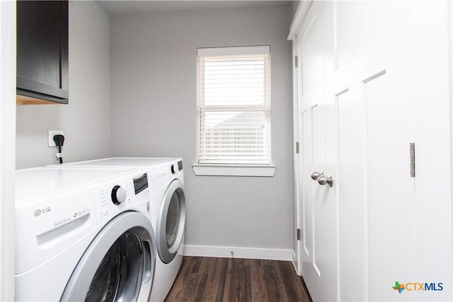 laundry room with a wealth of natural light, washer and dryer, dark wood-style flooring, and cabinet space