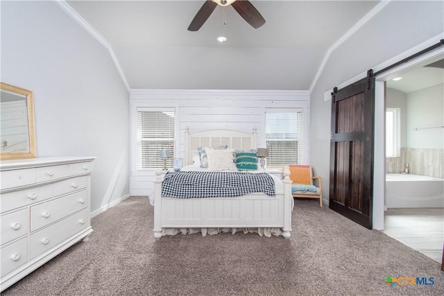 bedroom with carpet floors, a barn door, ornamental molding, and vaulted ceiling