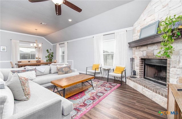 living room with a fireplace, wood finished floors, visible vents, vaulted ceiling, and crown molding