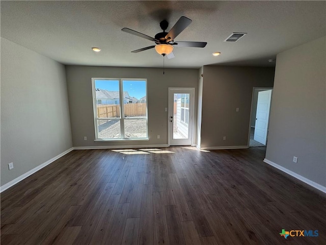 spare room featuring dark hardwood / wood-style floors, a textured ceiling, and ceiling fan