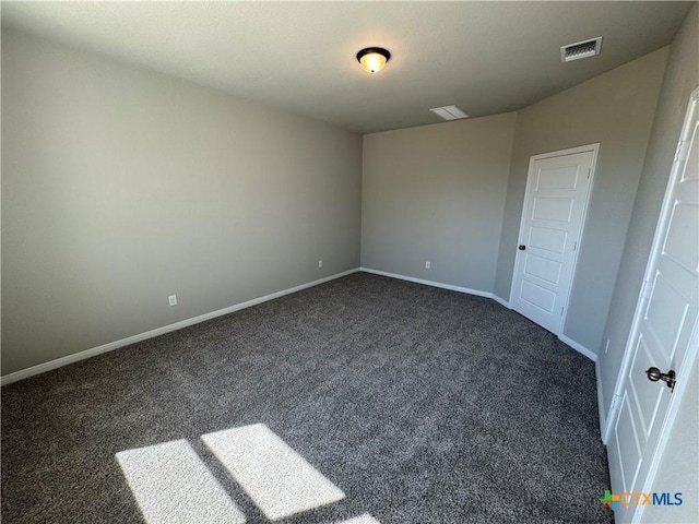 unfurnished bedroom featuring dark carpet