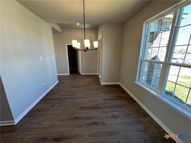 spare room featuring a textured ceiling and dark colored carpet