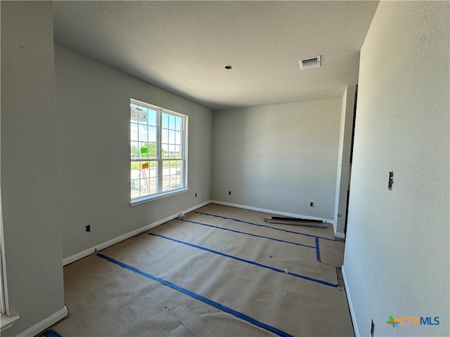 spare room featuring a textured ceiling