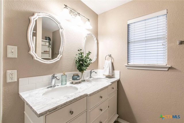 bathroom with double vanity and a sink