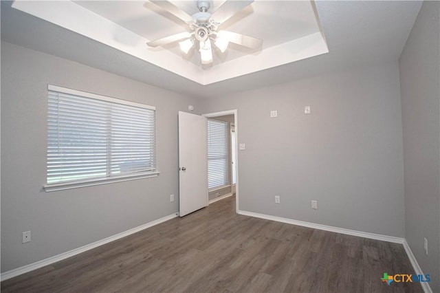 1614 Twisted Oak Dr, Temple, TX 76502 - spare room featuring a raised ceiling, wood finished floors, a ceiling fan, and baseboards