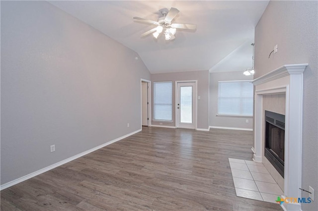 1614 Twisted Oak Dr, Temple, TX 76502 - unfurnished living room with lofted ceiling, a fireplace, wood finished floors, ceiling fan, and baseboards