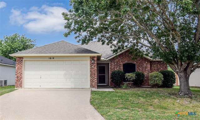1614 Twisted Oak Dr, Temple, TX 76502 - view of front of house featuring driveway, brick siding, a garage, and a front lawn