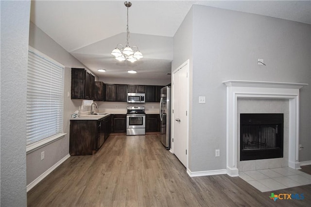 1614 Twisted Oak Dr, Temple, TX 76502 - kitchen featuring stainless steel appliances, dark brown cabinetry, vaulted ceiling, a chandelier, and light wood finished floors
