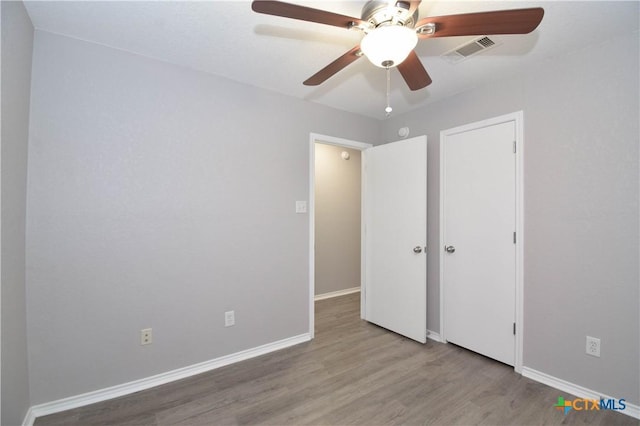 1614 Twisted Oak Dr, Temple, TX 76502 - unfurnished bedroom with wood finished floors, baseboards, and a ceiling fan