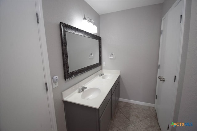 1614 Twisted Oak Dr, Temple, TX 76502 - bathroom featuring double vanity, tile patterned flooring, and baseboards