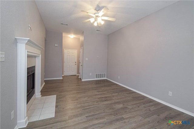 1614 Twisted Oak Dr, Temple, TX 76502 - unfurnished living room with ceiling fan, wood finished floors, a fireplace with flush hearth, and baseboards