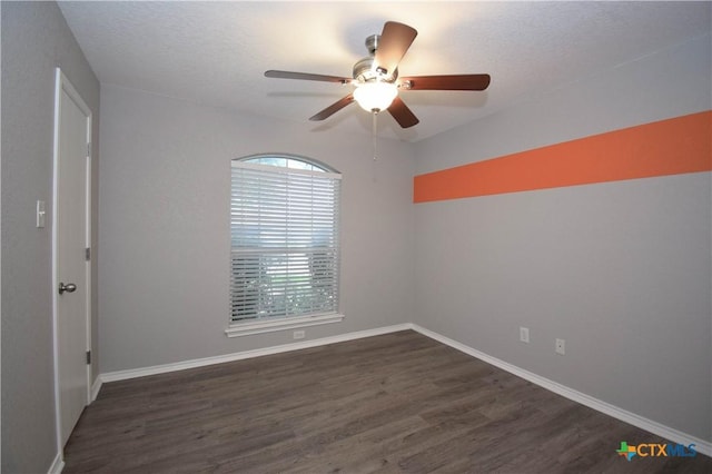 1614 Twisted Oak Dr, Temple, TX 76502 - empty room with dark wood finished floors, a ceiling fan, baseboards, and a textured ceiling