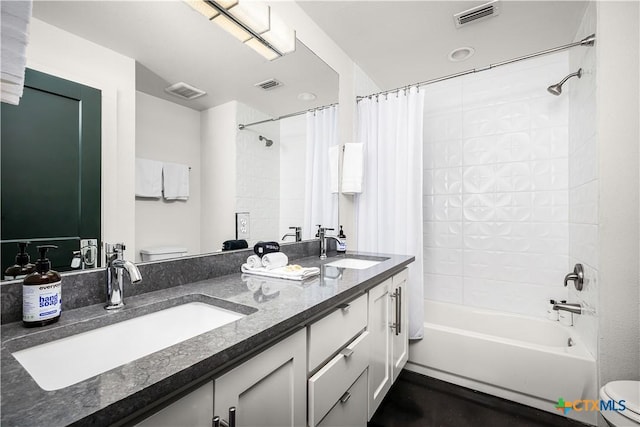 full bathroom with shower / bath combo, toilet, and vanity