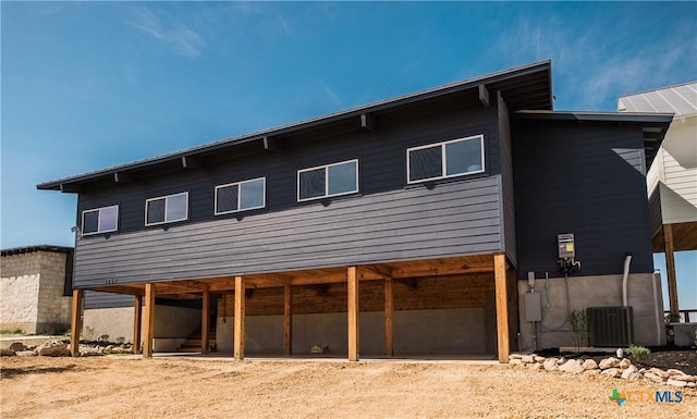 rear view of house featuring central AC unit