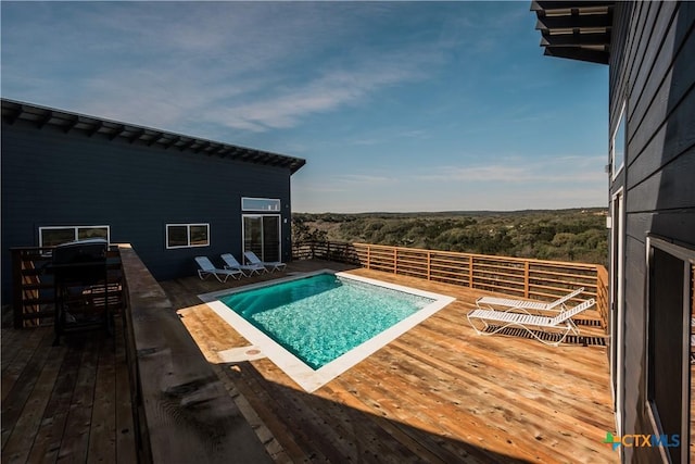 view of pool with a wooden deck