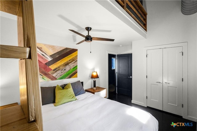 bedroom with hardwood / wood-style floors, a closet, and ceiling fan