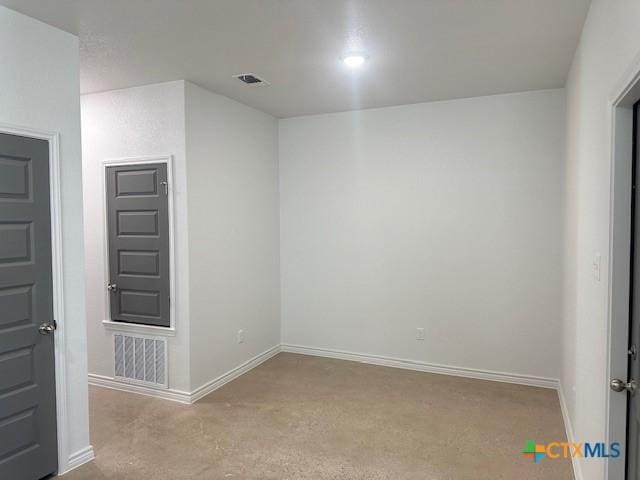 empty room featuring visible vents and baseboards