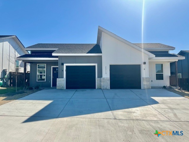 view of front of property with concrete driveway and an attached garage