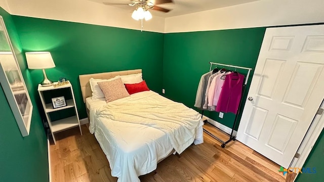 bedroom with hardwood / wood-style floors and ceiling fan