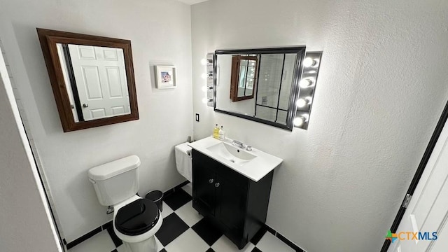 bathroom featuring toilet, tile patterned floors, and vanity