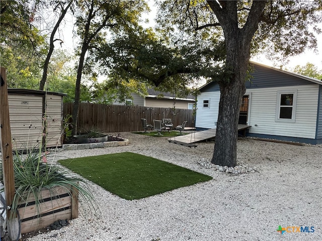 view of yard with a patio and a storage shed