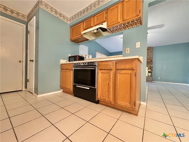 kitchen with lofted ceiling, a textured ceiling, and light tile patterned floors