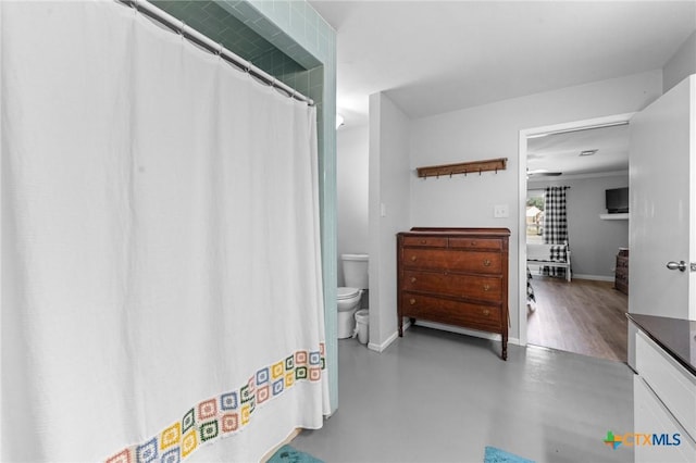 bathroom featuring concrete flooring, vanity, toilet, and a shower with curtain