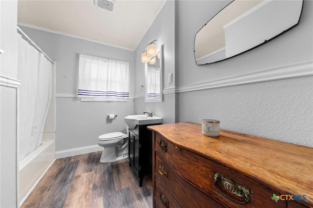 bathroom featuring toilet, wood finished floors, vanity, and crown molding